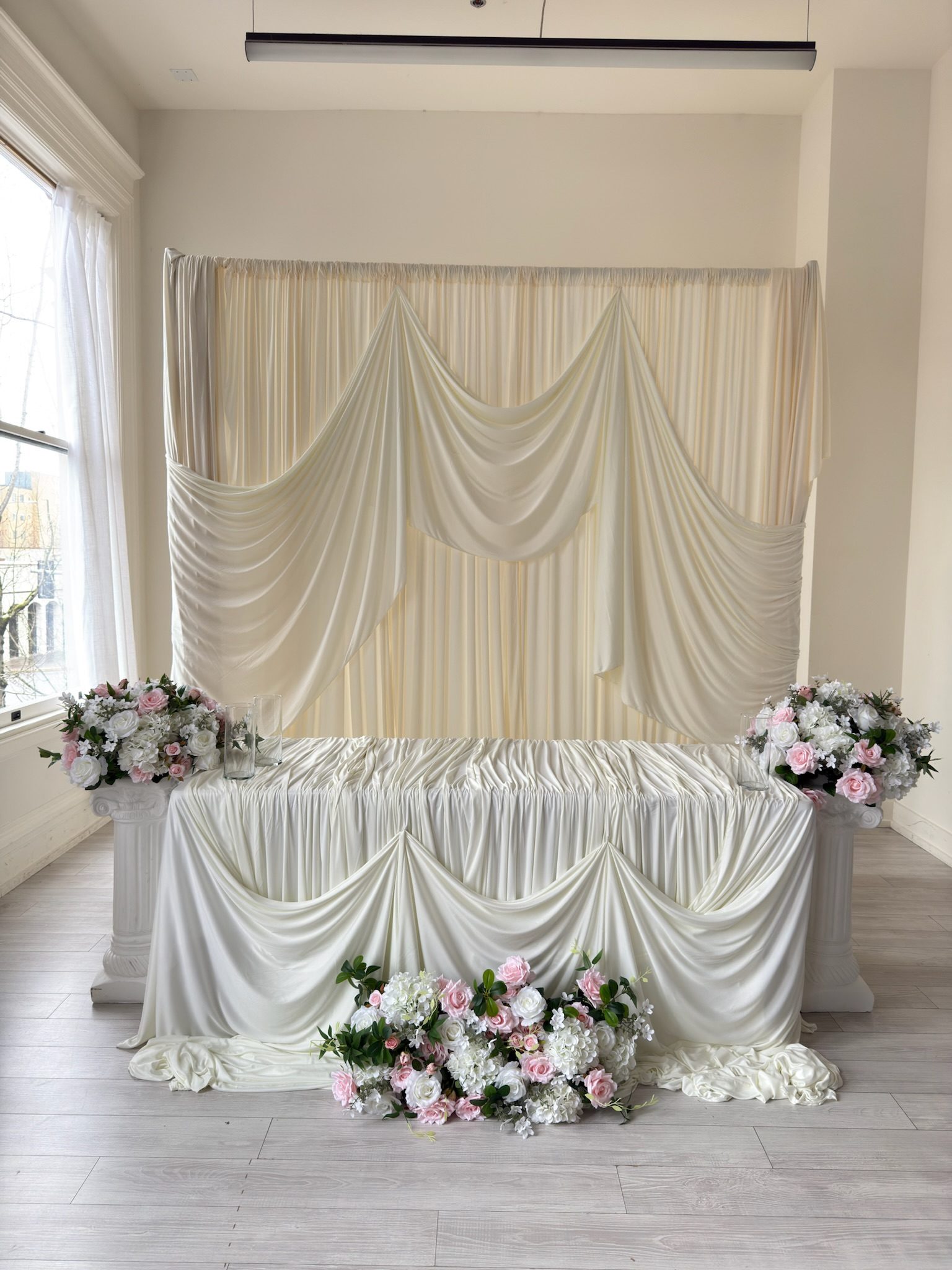 Ivory wedding ceremony backdrop with sweetheart table